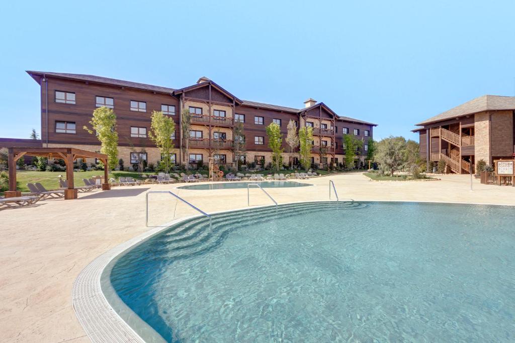 una grande piscina di fronte a un edificio di PortAventura Hotel Colorado Creek - Includes PortAventura Park Tickets a Salou