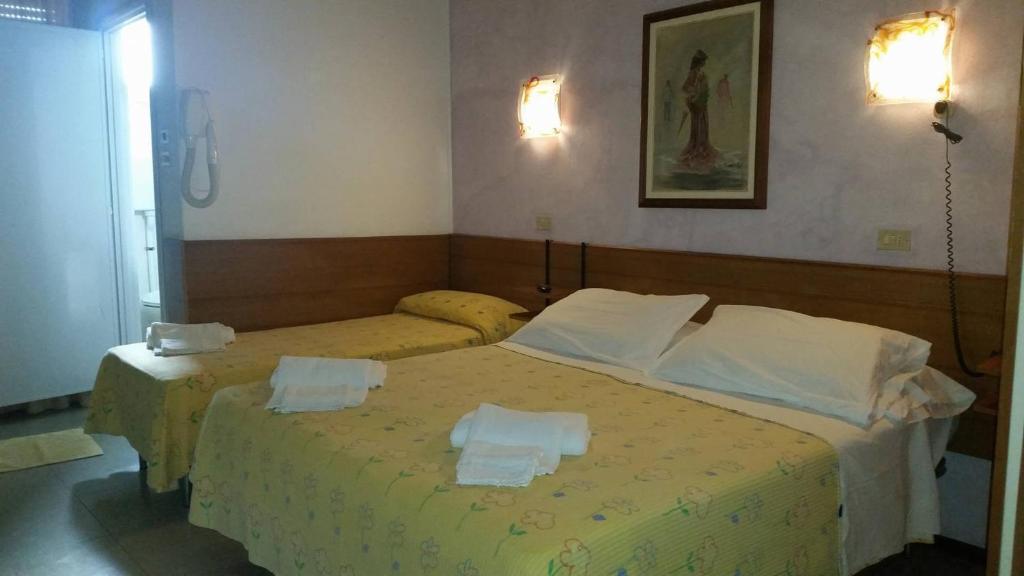 Postel nebo postele na pokoji v ubytování Hotel Pecci