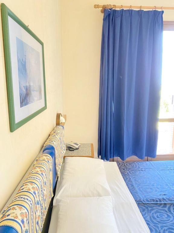 Postel nebo postele na pokoji v ubytování Tramonti Residence