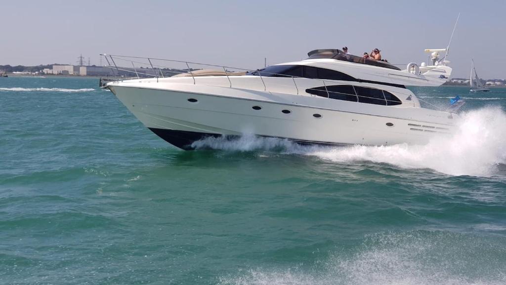 un barco blanco en el agua en el océano en Luxury Italian Motor Yacht en Hamble