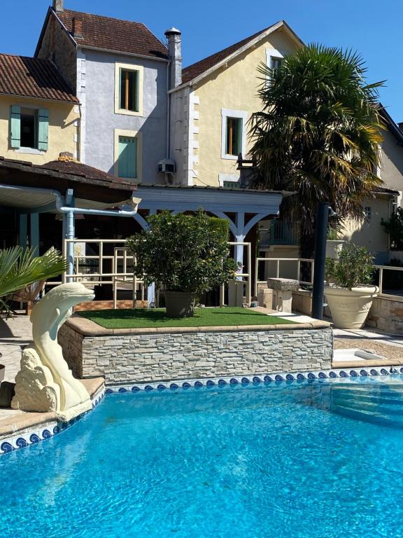 a swimming pool in front of a house at Le Relax in Boulazac