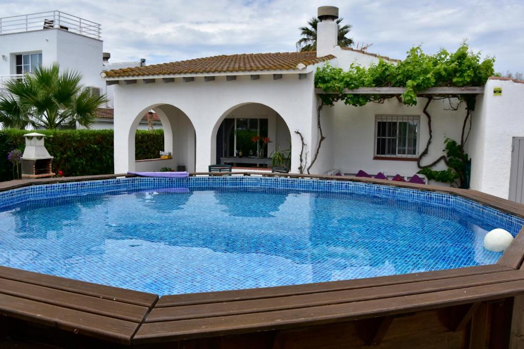 a swimming pool in a backyard with a house at Casa Daguet in L'Eucaliptus