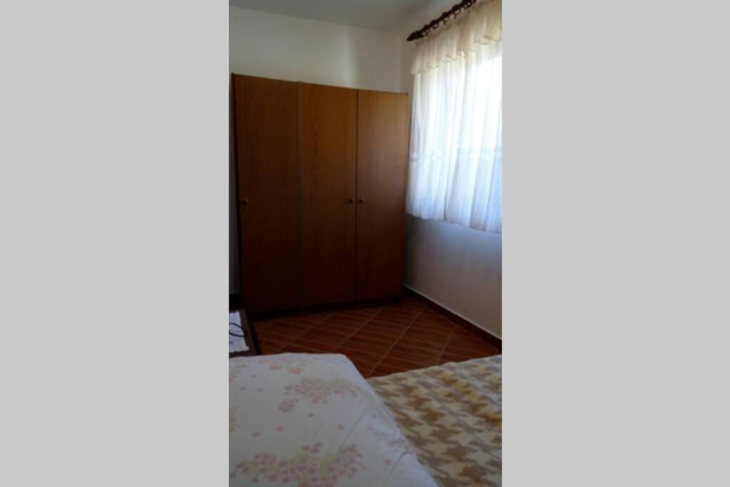 an empty bedroom with a bed and a window at Apartment Zdenka in Raša
