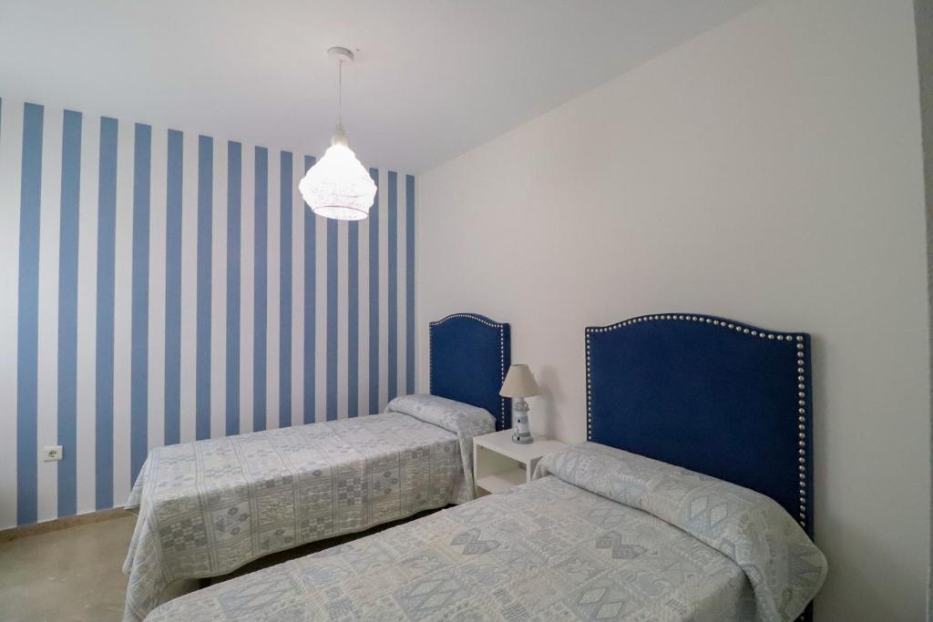 Posteľ alebo postele v izbe v ubytovaní Ohana Beachfront