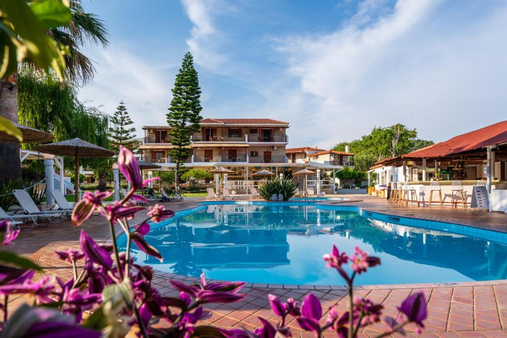 uma grande piscina com uma casa ao fundo em Almira Hotel em Troulos