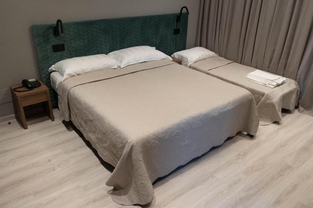 Кровать или кровати в номере Hotel Graziella