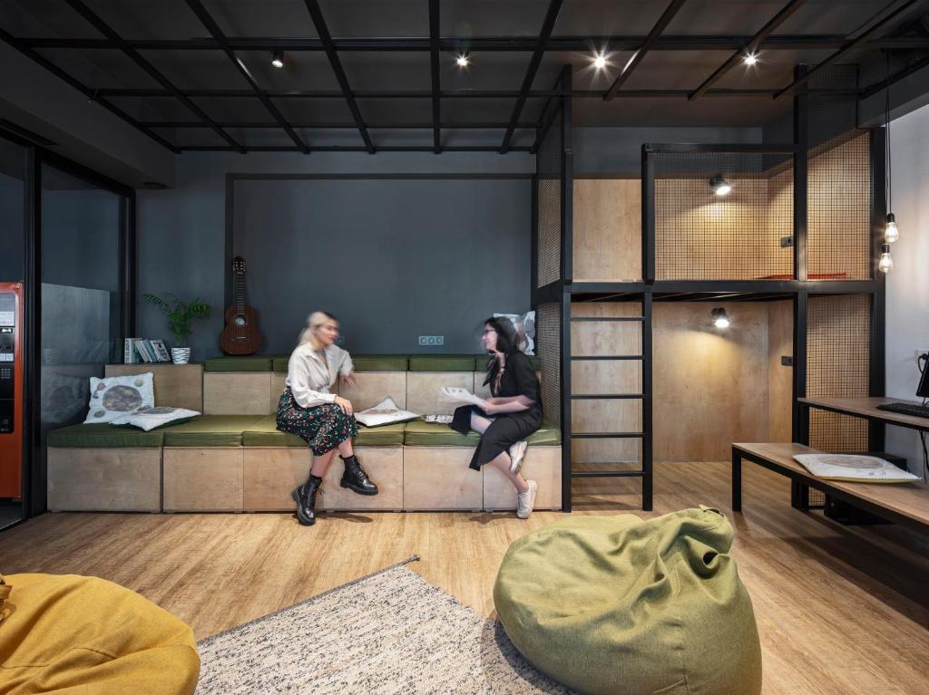 two women sitting on a couch in a room at Kantar Hostel in Yerevan