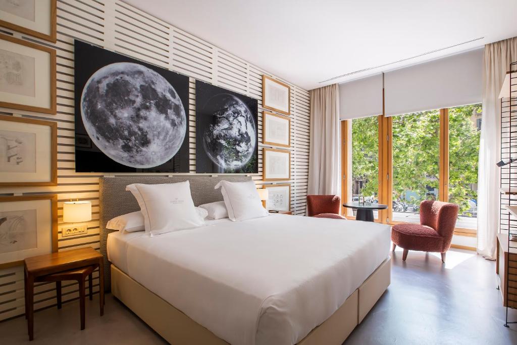 a bedroom with a large white bed and a window at Hotel Margot House Barcelona in Barcelona
