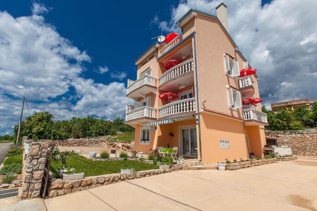 a large building with balconies on the side of it at Apartments Villa Americana in Jadranovo