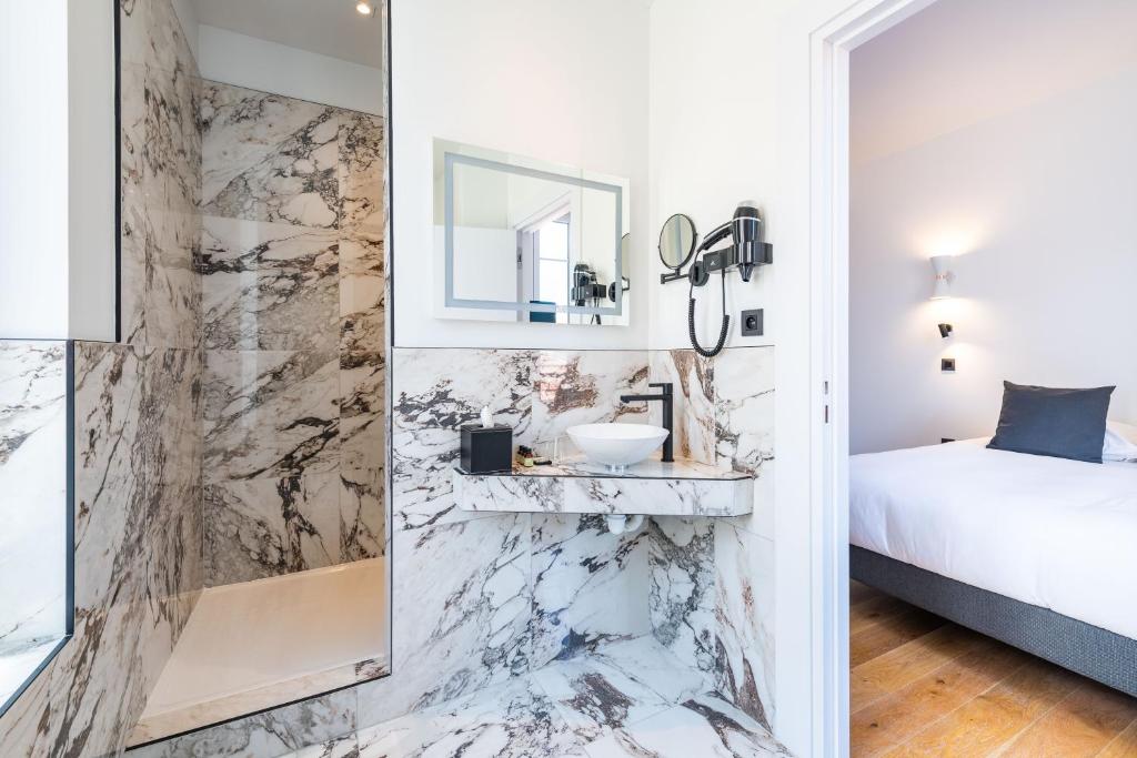 a bathroom with a sink and a mirror at Boutique Hotel Nice Côte d'azur in Nice