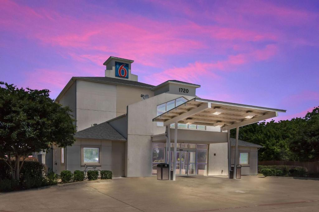 a building with a clock tower on top of it at Motel 6-Cleburne, TX in Cleburne