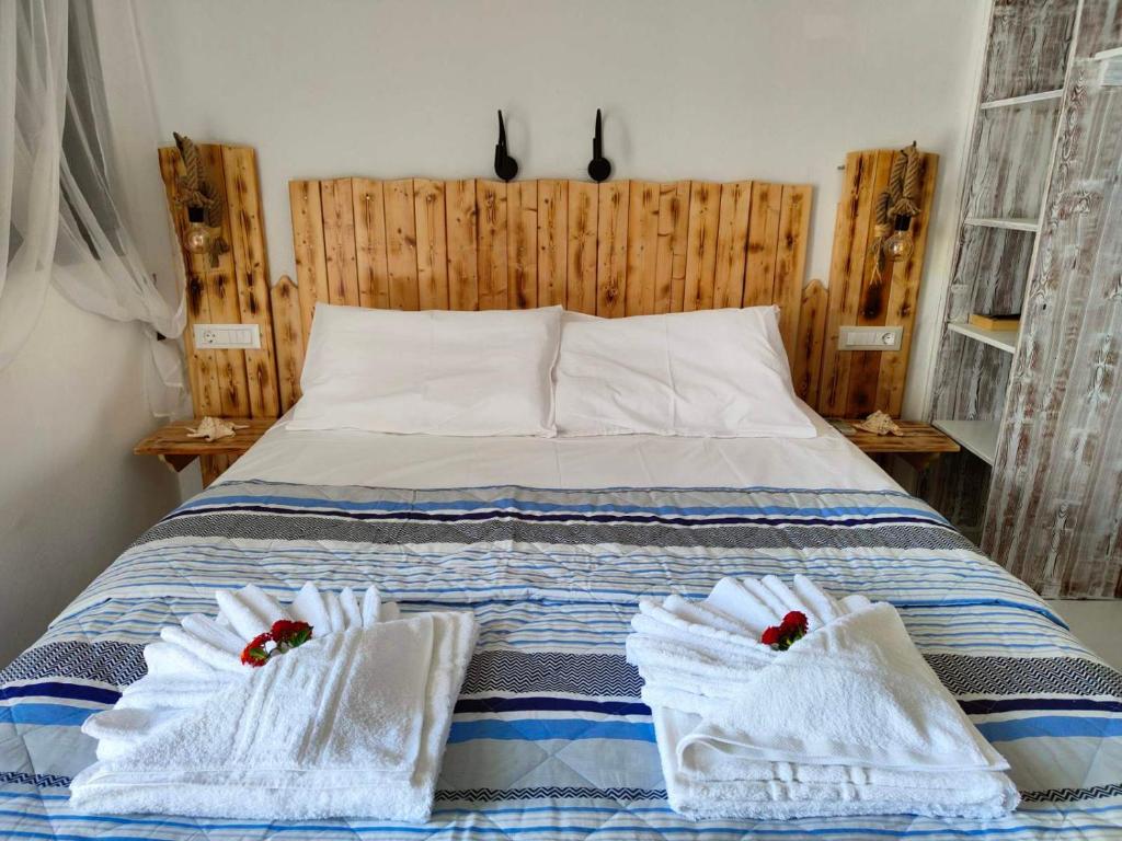 a bedroom with a bed with towels on it at Sea Sound Haraki apartment in Haraki