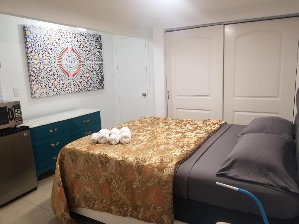 a bedroom with a bed with three white balls on it at 1161 Studio 2 Main Miami in Miami