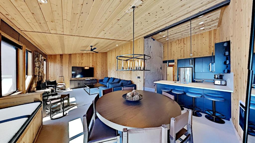 a kitchen and living room with a wooden ceiling at Beautifully remodeled 3 Bedroom Condo in Mammoth Lakes