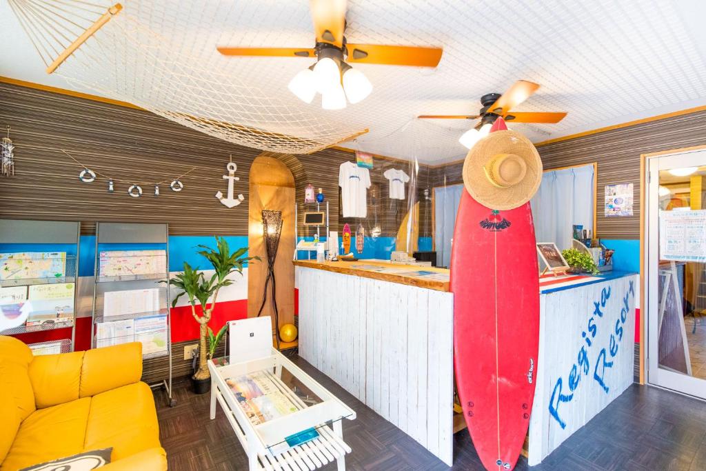 una tienda con tablas de surf en la pared en una habitación en Seaside Pension Petit Shirahama, en Shirahama