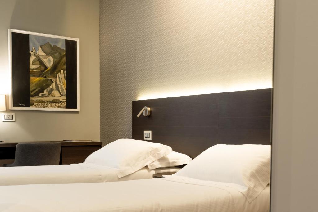 Posteľ alebo postele v izbe v ubytovaní Hotel Michelangelo