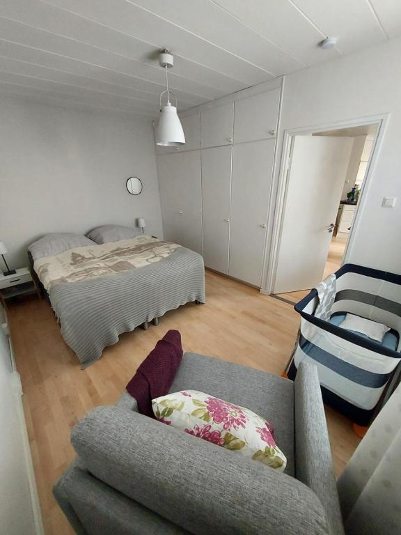a living room with a couch and a bed at Garden Street Family in Turku