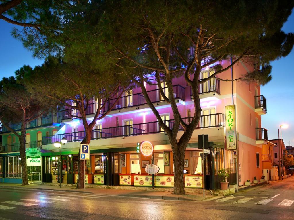 a building on the side of a street at night at Hotel Storione in Lido di Jesolo