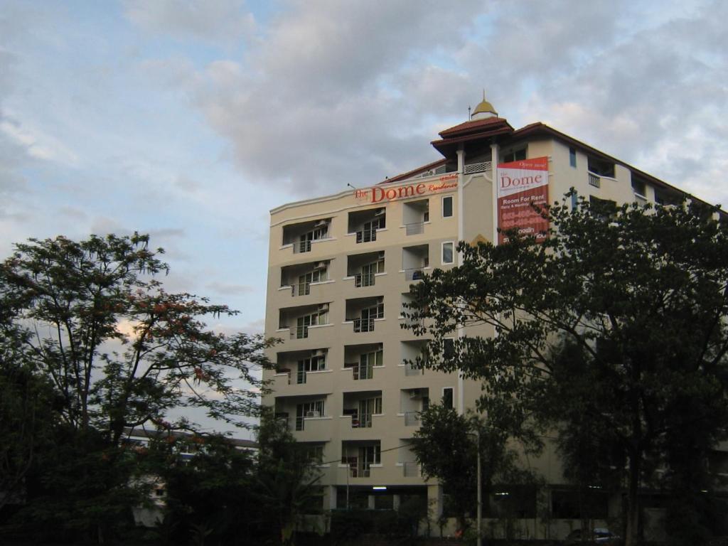 Un bâtiment blanc avec un panneau en haut dans l'établissement The Dome Residence, à Chiang Mai