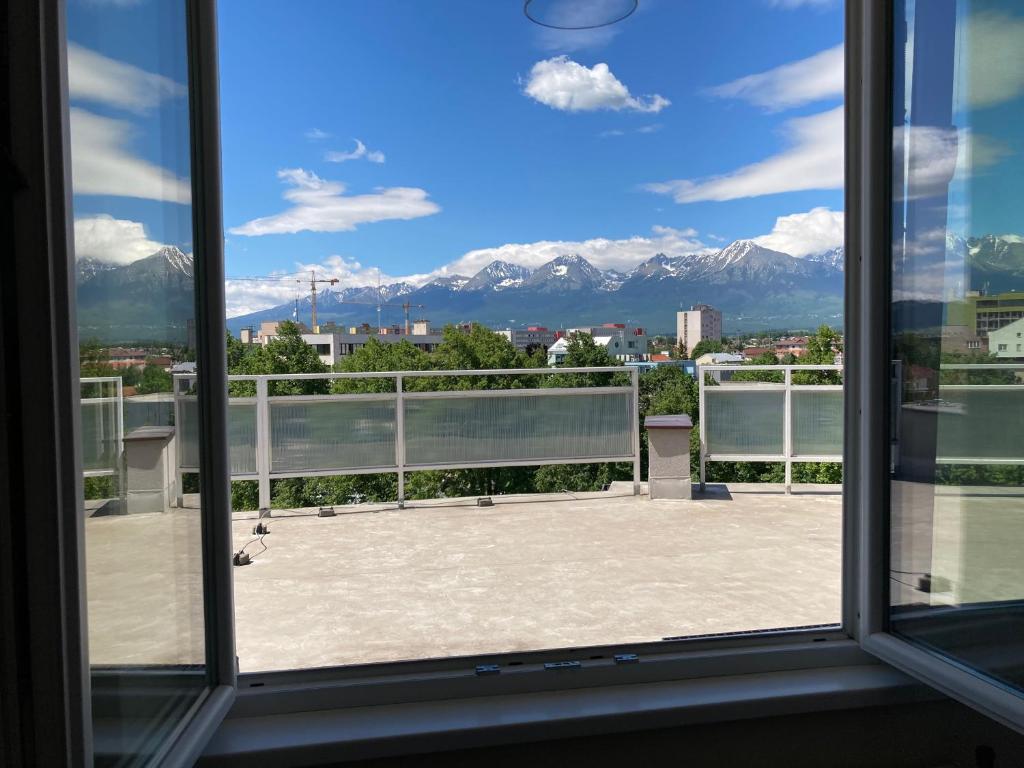 a view from a window of a balcony with mountains at Apartman HIGHTATRAS VIEW Centrum Poprad in Poprad