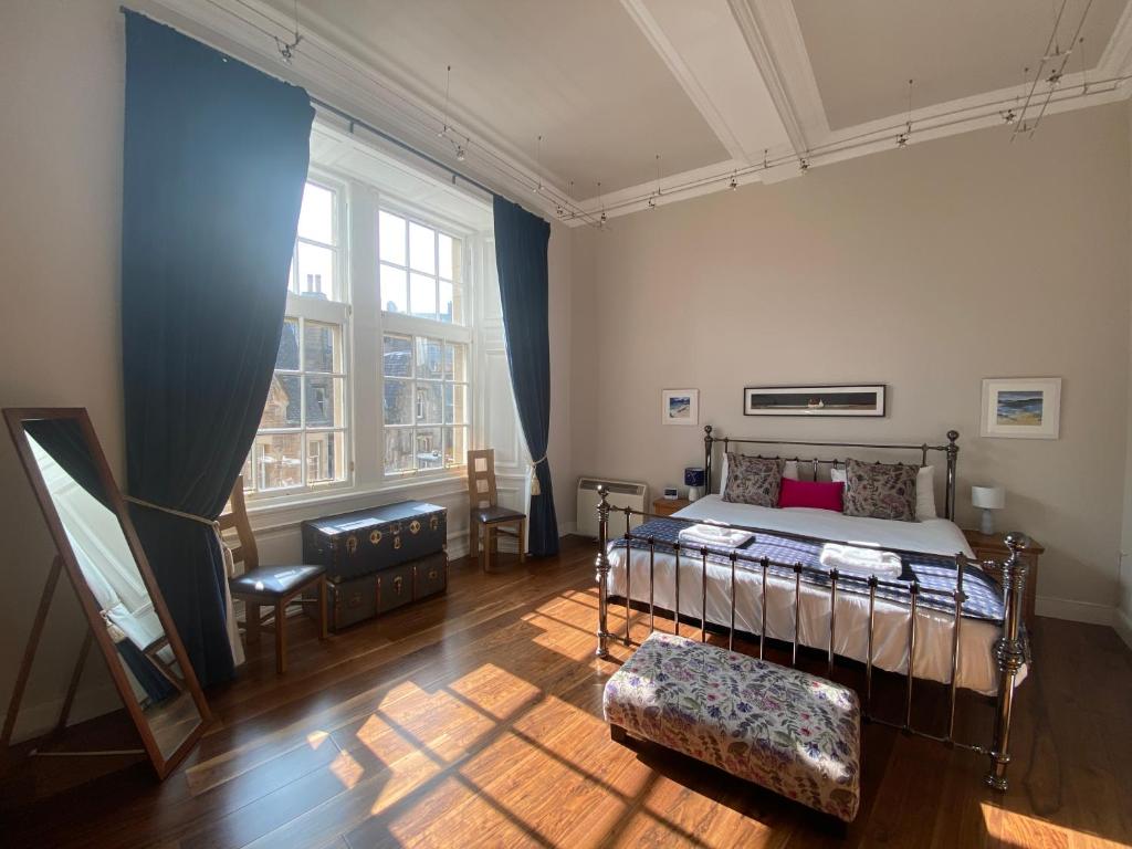 a bedroom with a bed and a table and chairs at Royal Mile Mansions by Edinburgh City Apartments in Edinburgh