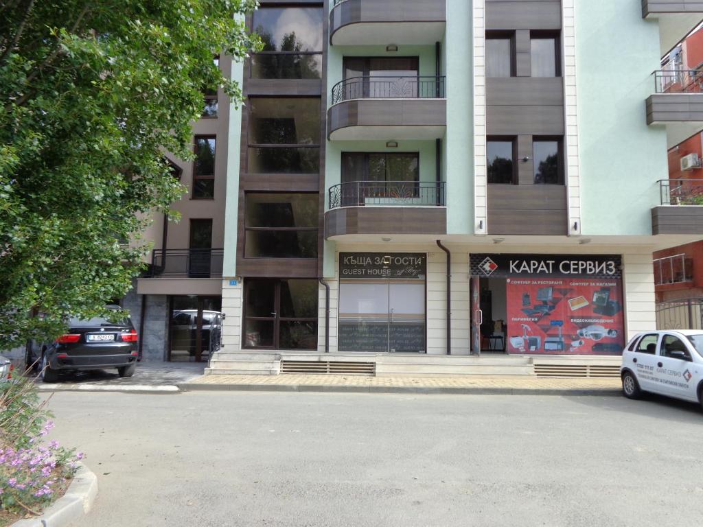 a building with a car parked in front of it at Къща за гости А. Б. В. in Nesebar