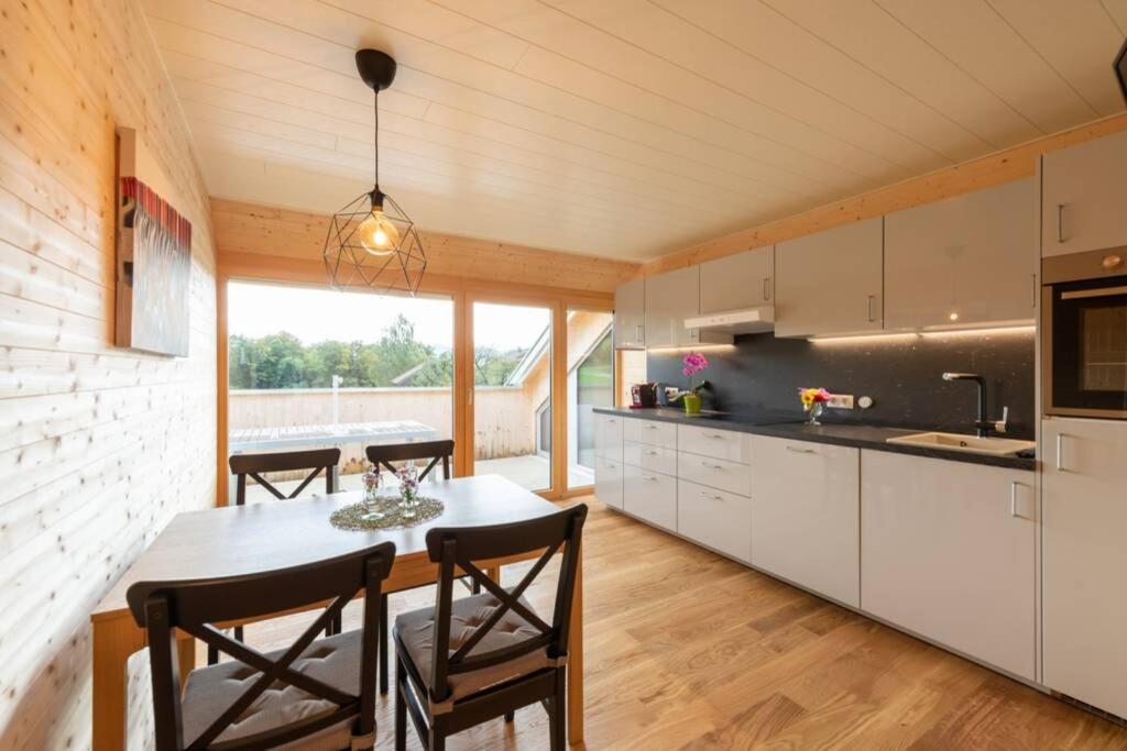 a kitchen with a table and chairs in a room at Rosenhaus 1 in Schwarzenberg