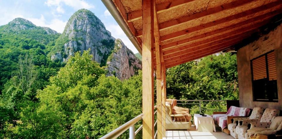 a porch with chairs and a view of mountains at Odmaralište Vlaško ždrelo in Pirot