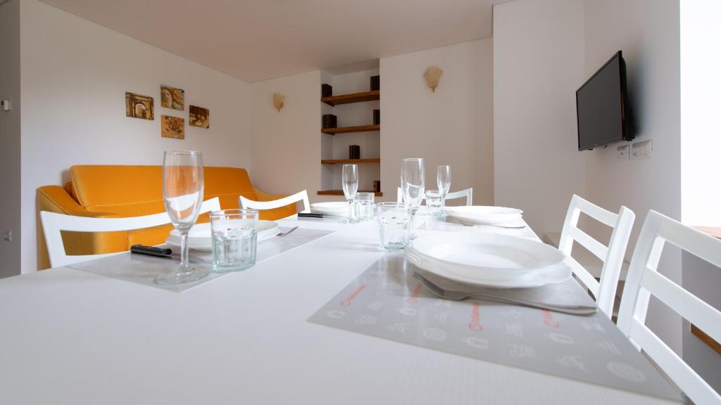 a white dining room table with a white plate on it at Italianway - Villa Tola in Valdisotto