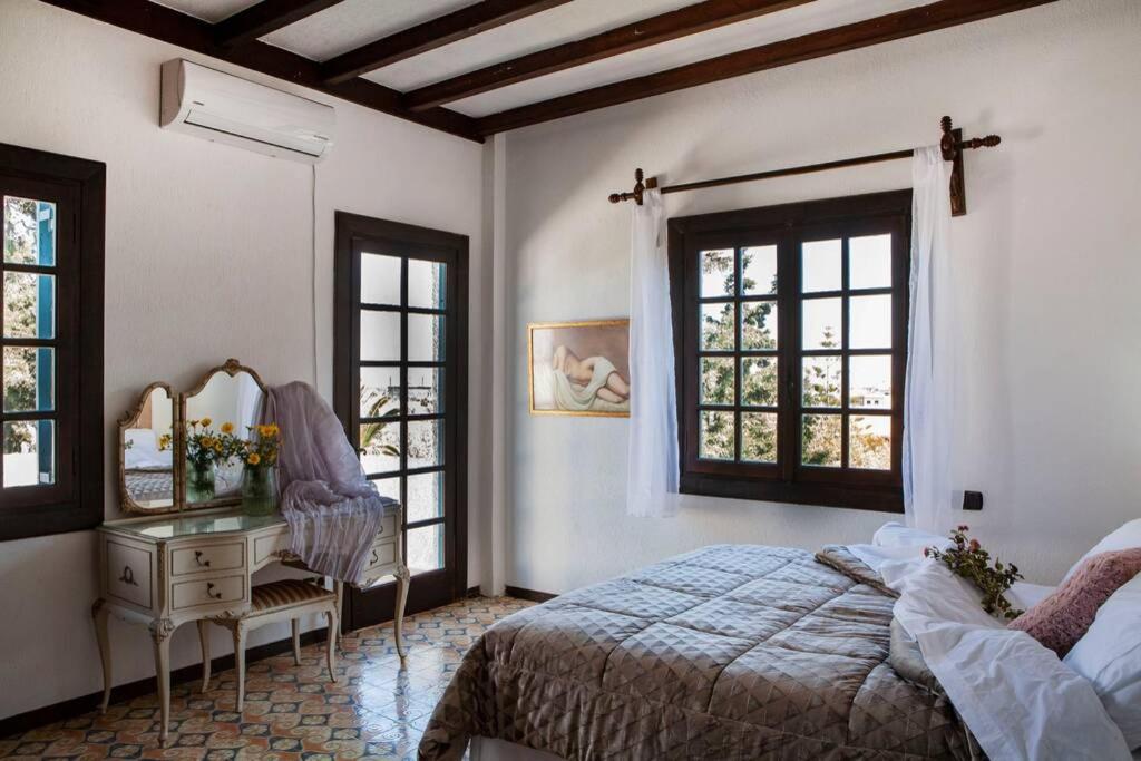 A bed or beds in a room at Villa Velissarios: wonderful villa next to beach