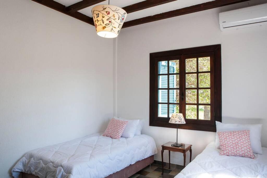 A bed or beds in a room at Villa Velissarios: wonderful villa next to beach