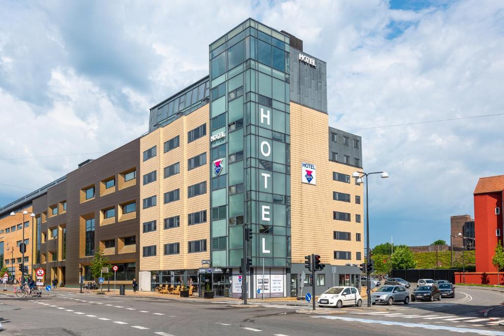 a tall building on the corner of a street at Cabinn Odense in Odense