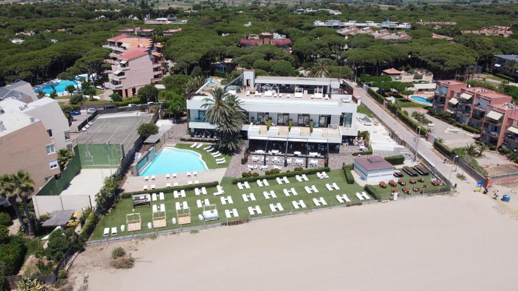 an aerial view of a resort with a pool and beach at Playa Grande by Tropical - Adults Only in Gavà