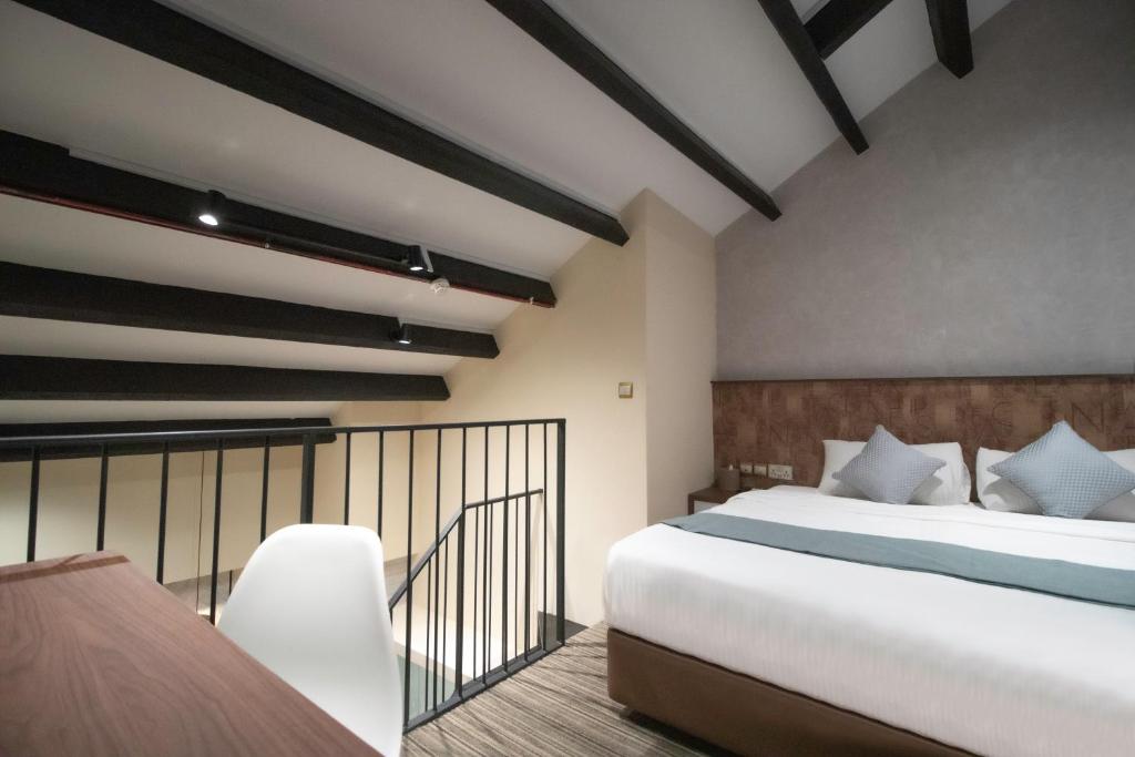um quarto com uma cama grande e uma varanda em Harbour Ville Hotel - Hamilton em Singapura
