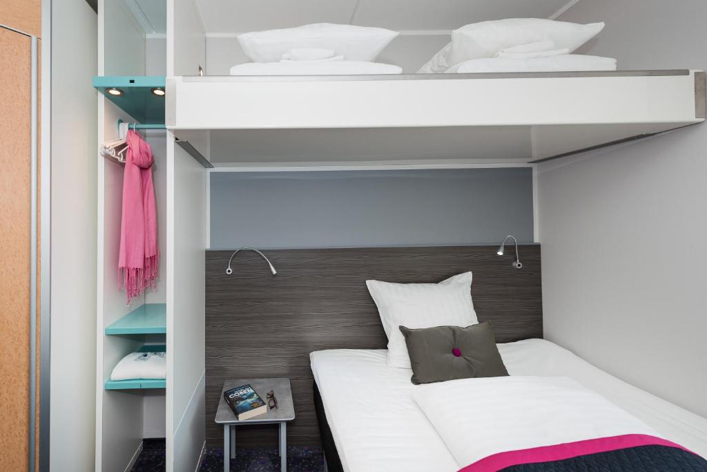 Postel nebo postele na pokoji v ubytování Cabinn Odense