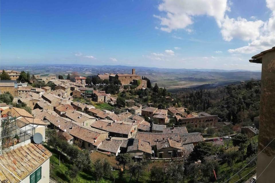 a village on a hill with roofs at Historic Center Apartment with Private Garage in Montalcino