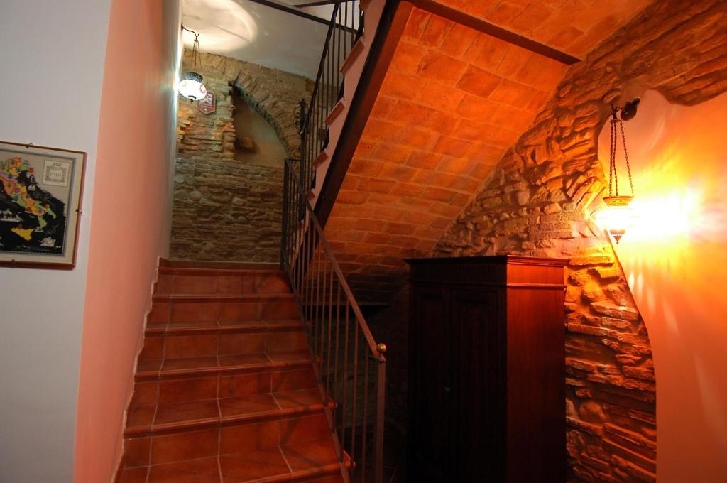 a staircase in a room with a stone wall at B&B La Giuggiola Lanciano in Lanciano