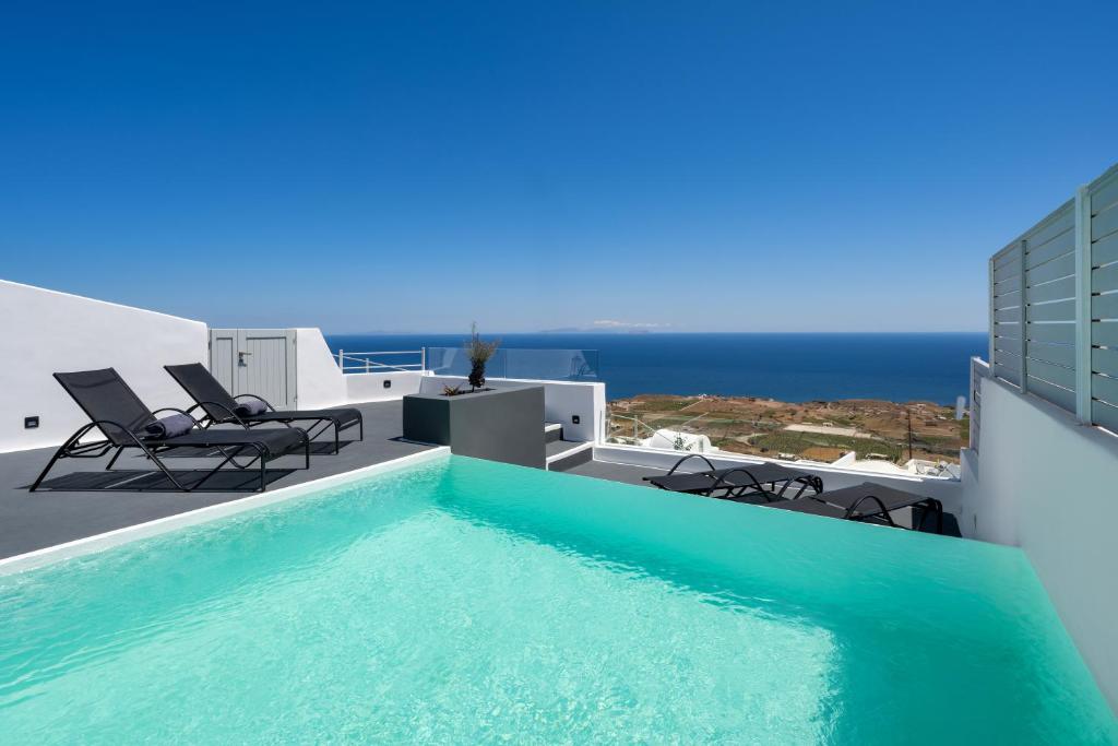 a swimming pool on the roof of a house at Siete Mares Luxury Suites in Imerovigli