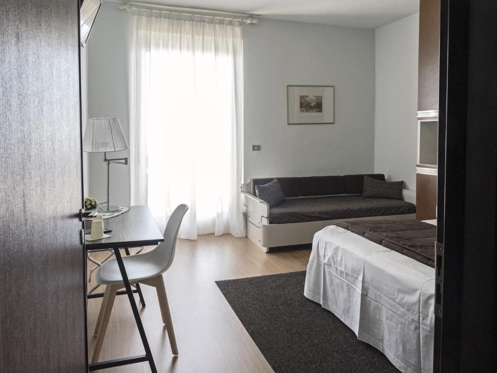 Postel nebo postele na pokoji v ubytování Hotel Funivia