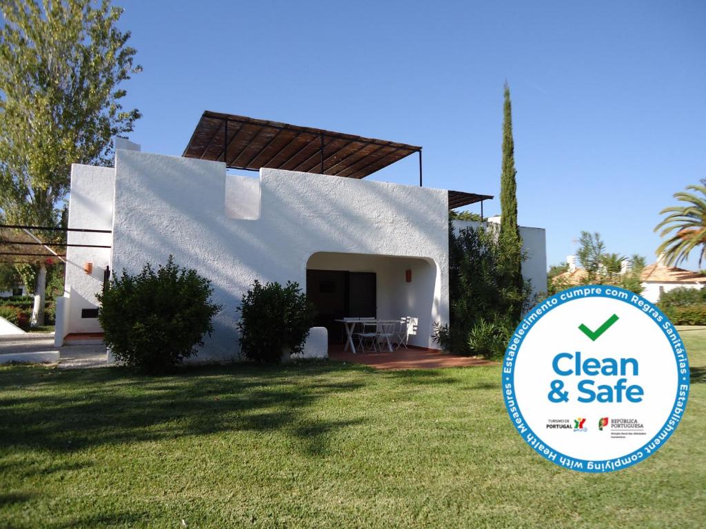 a house with a sign in front of it at Terrace Villa 19B in Santa Luzia