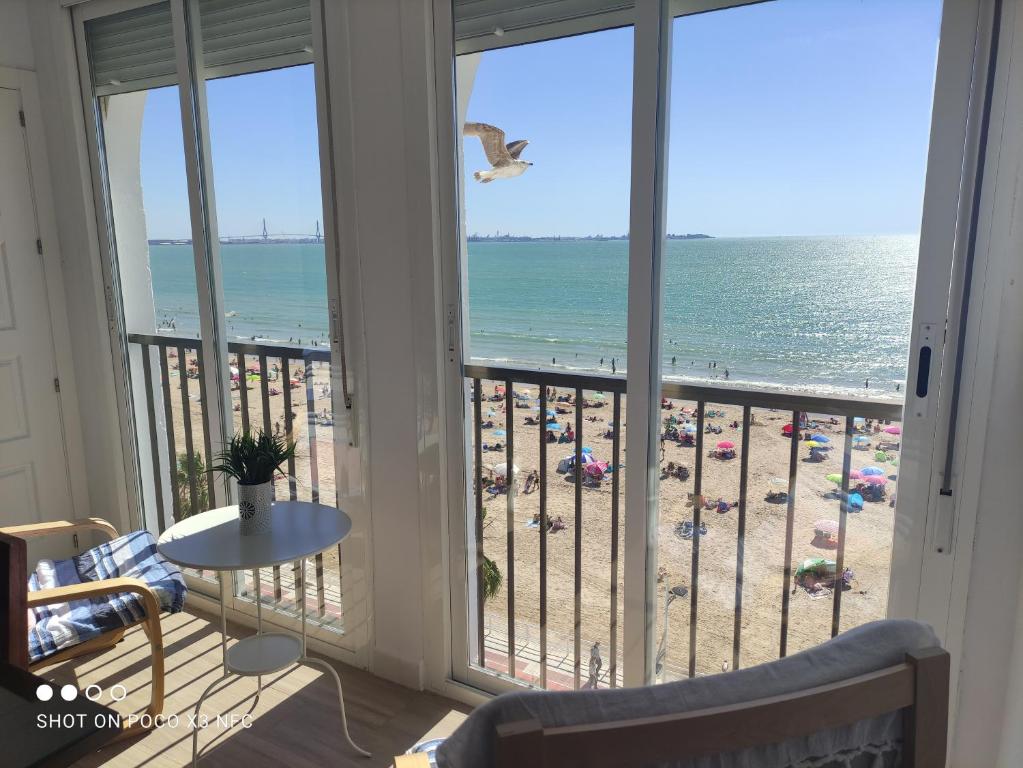 a view of the beach from a condo balcony at PRIMERA LINEA DE PLAYA EN VALDELAGRANA in El Puerto de Santa María