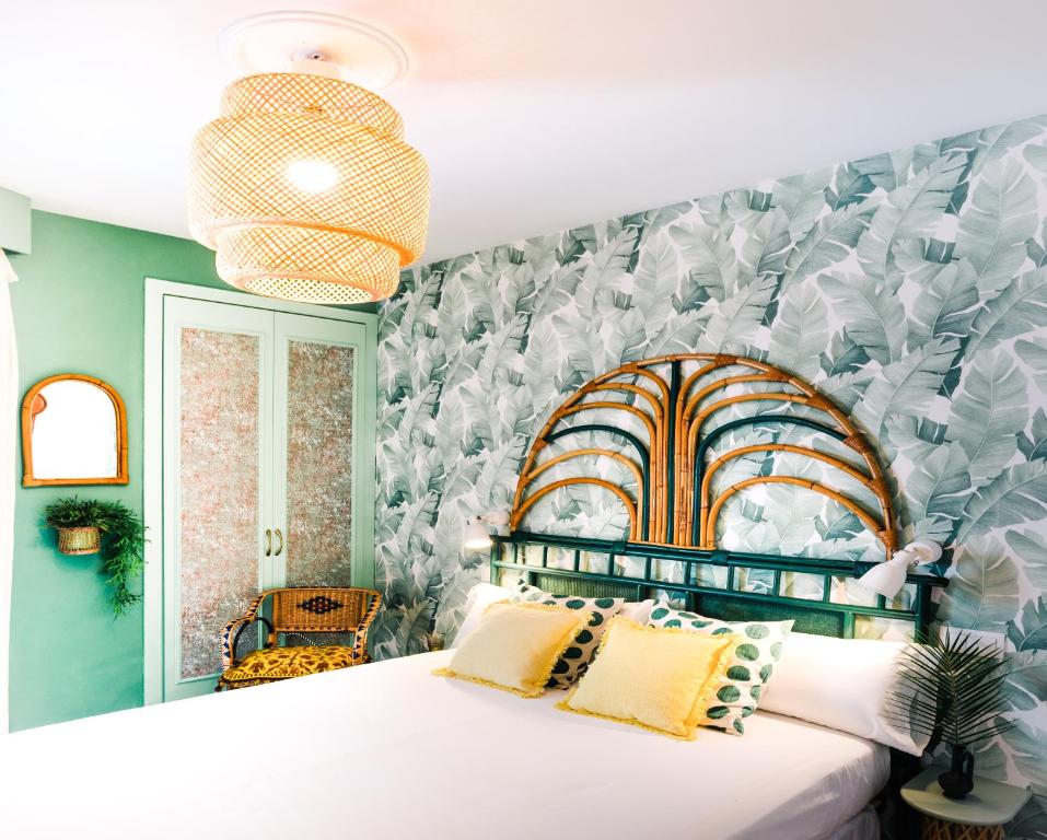 A bed or beds in a room at 1840 Apartments Sitges by Suma Hotels