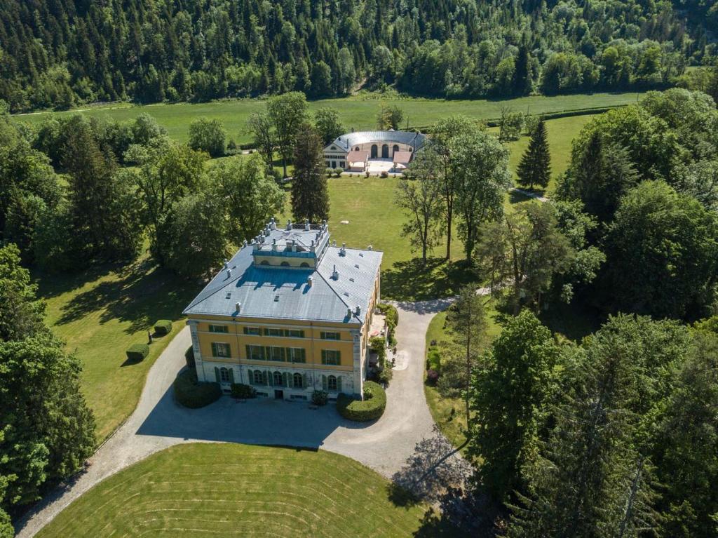 an aerial view of a large house in a field at La Villa Palladienne - Château de Syam in Syam