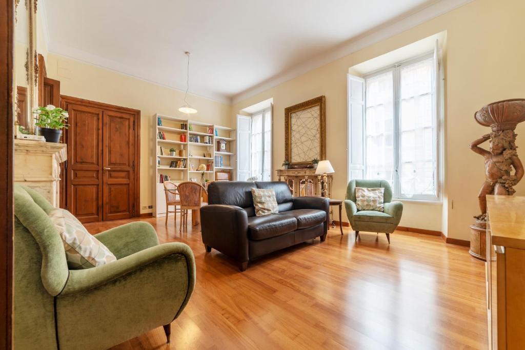 a living room with two chairs and a couch at Termini Central and Elegant Apartment in Rome