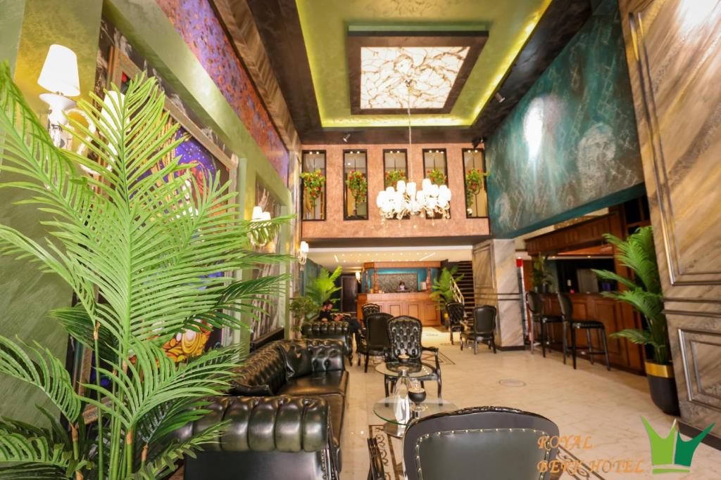 a lobby with chairs and plants in a building at Royal Berk Hotel in Van