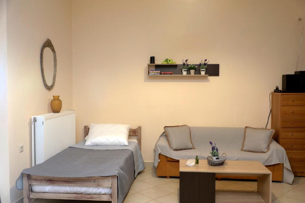 a room with a bed and a couch and a table at Zante Xigia Bay villas in Khartáta