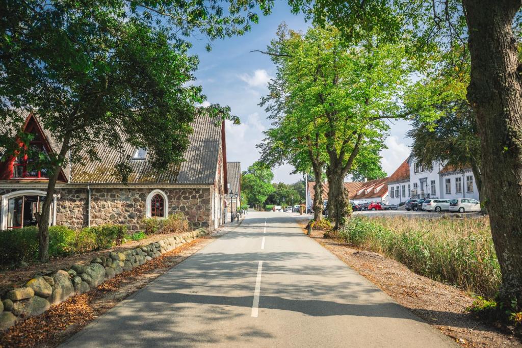 a street in a small town with trees at Sonnerupgaard Hotel & Konference in Kirke-Hvalsø