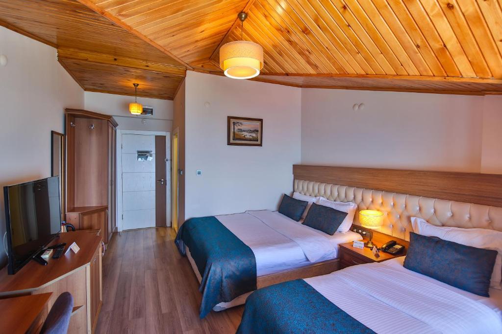 Postel nebo postele na pokoji v ubytování Amasra Diamond Hotel