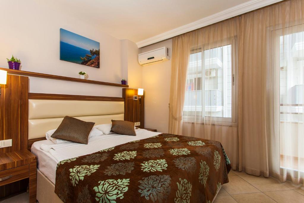 Postel nebo postele na pokoji v ubytování Oba Time Hotel