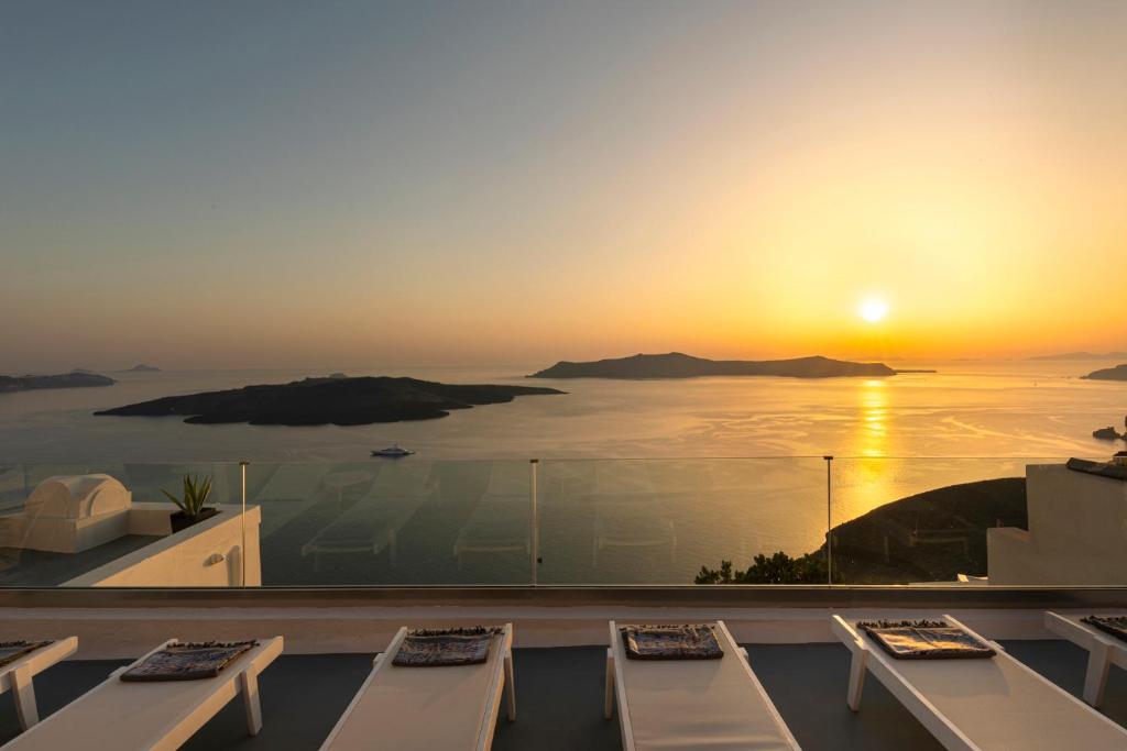 a view of the sunset from the balcony of a hotel at Caldera Senses in Fira